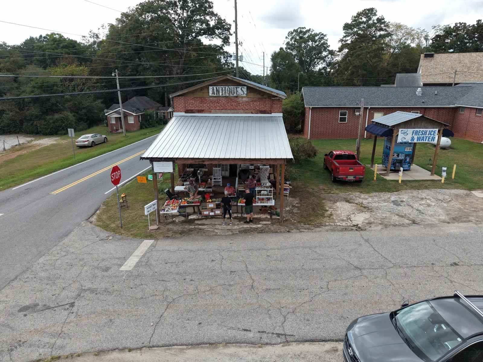 Aerial perspective of a roadside commercial property and neighboring buildings