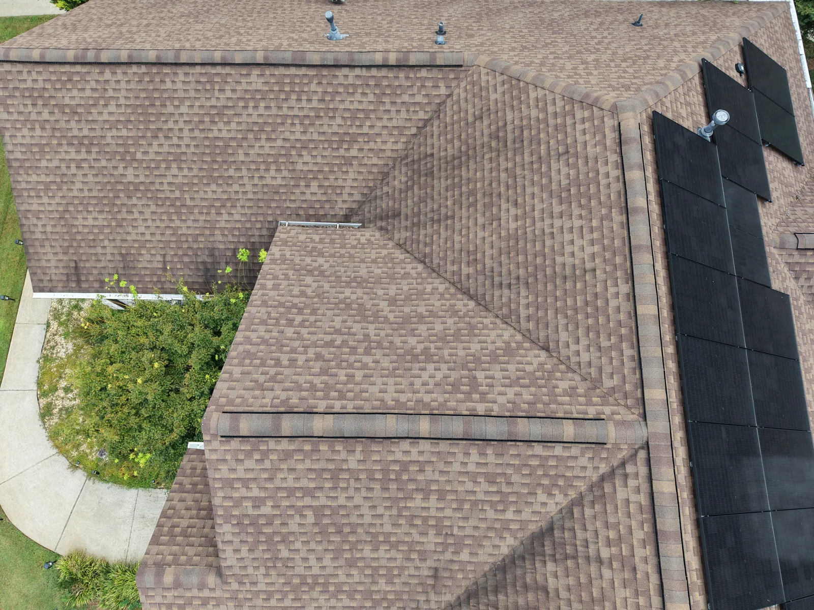 Closer aerial view of a shingle roof and adjoining roofline