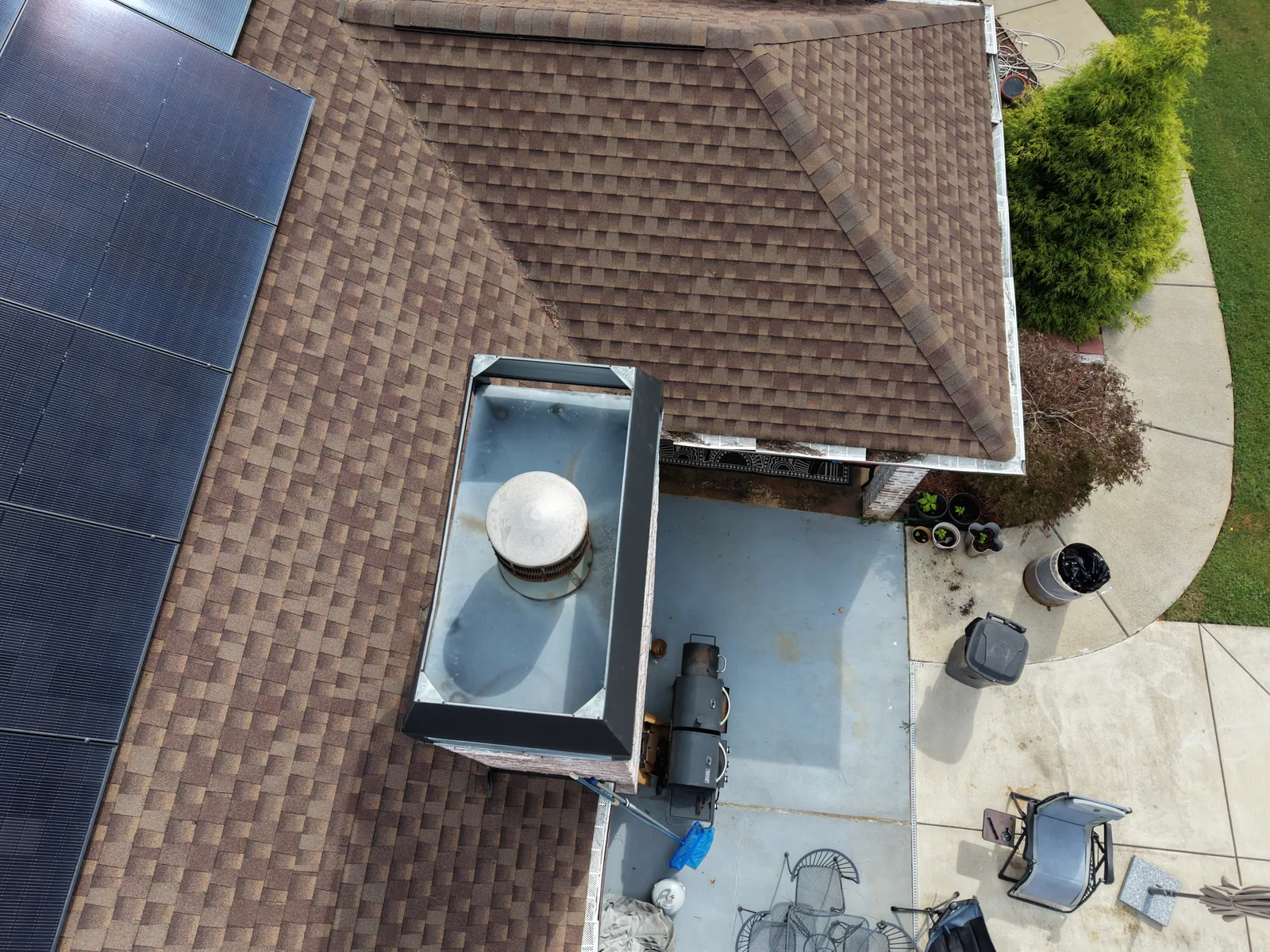 Top-down detail of a rooftop vent and nearby roof surfaces